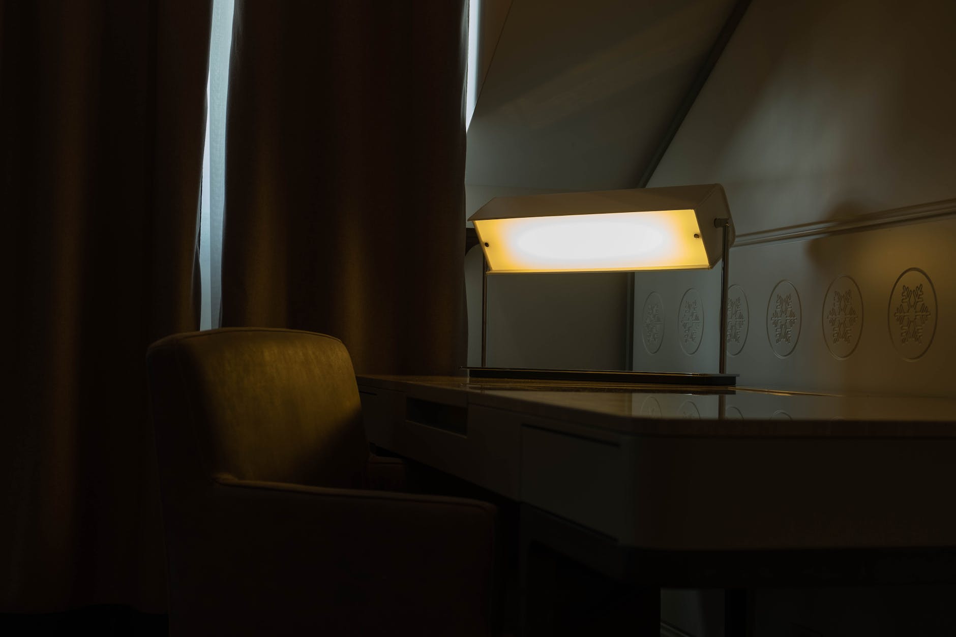 desk and an armchair with a lamp